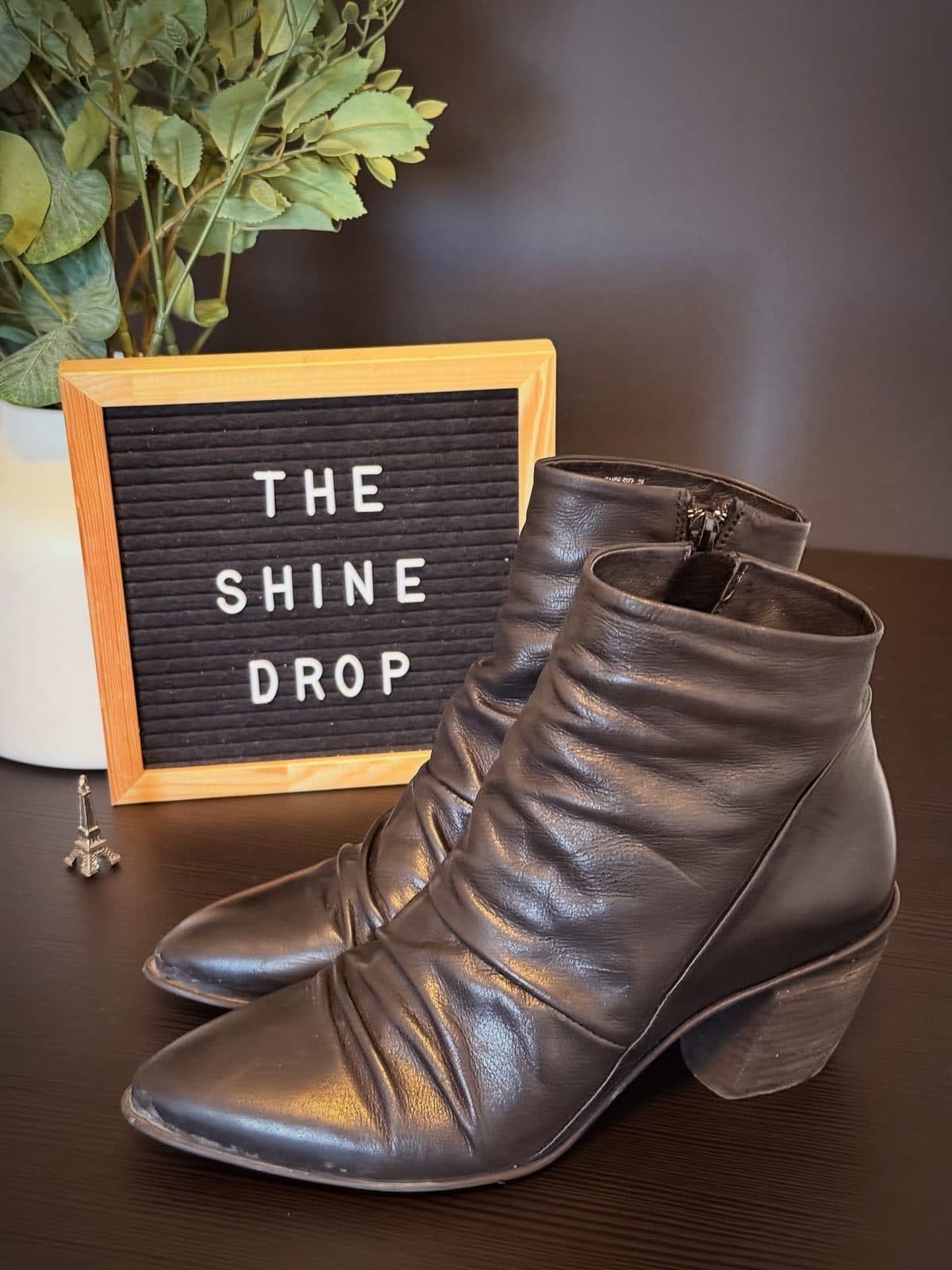 Black leather ankle boots before cleaning