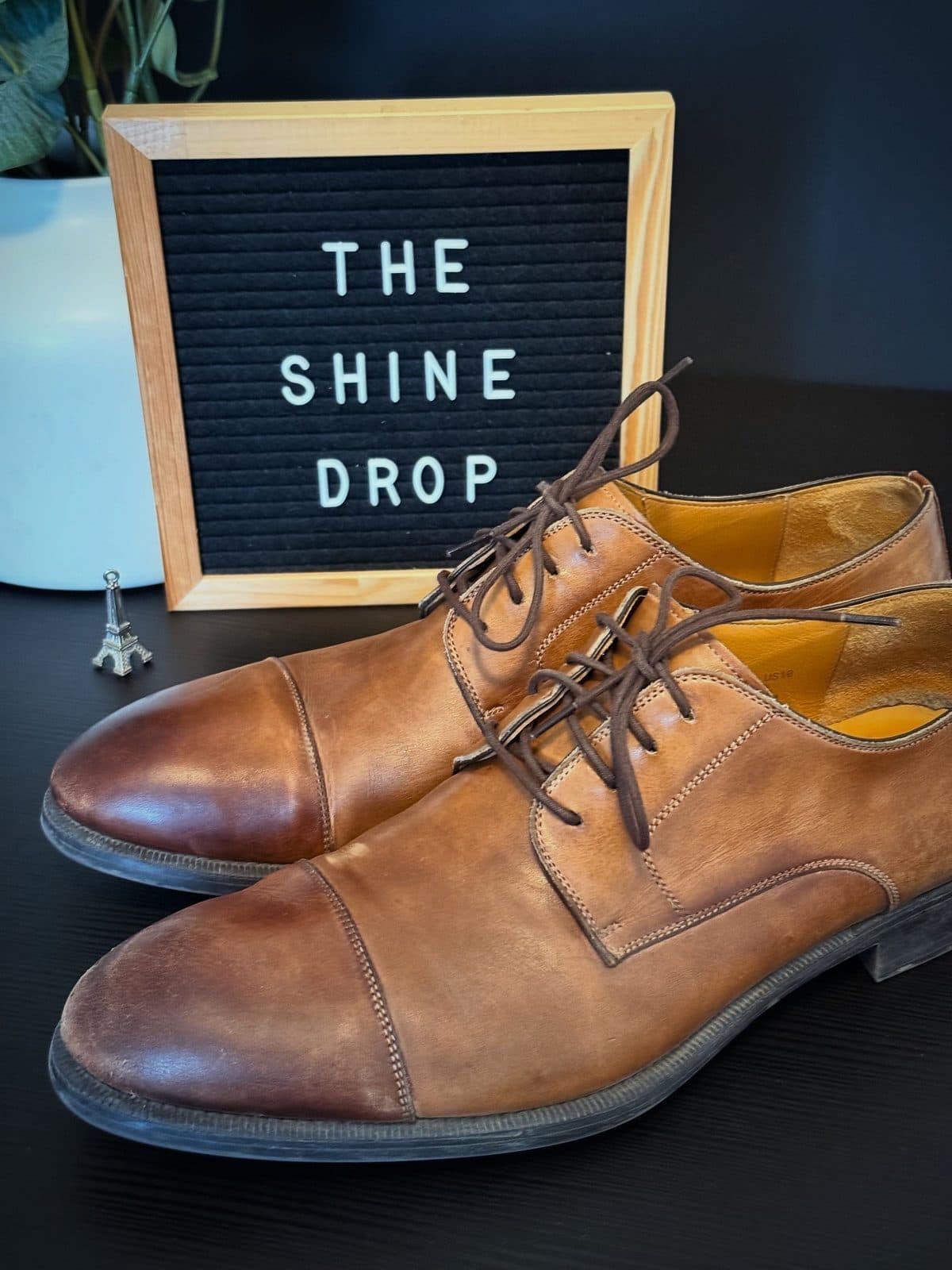 Tan cap-toe derbies before cleaning
