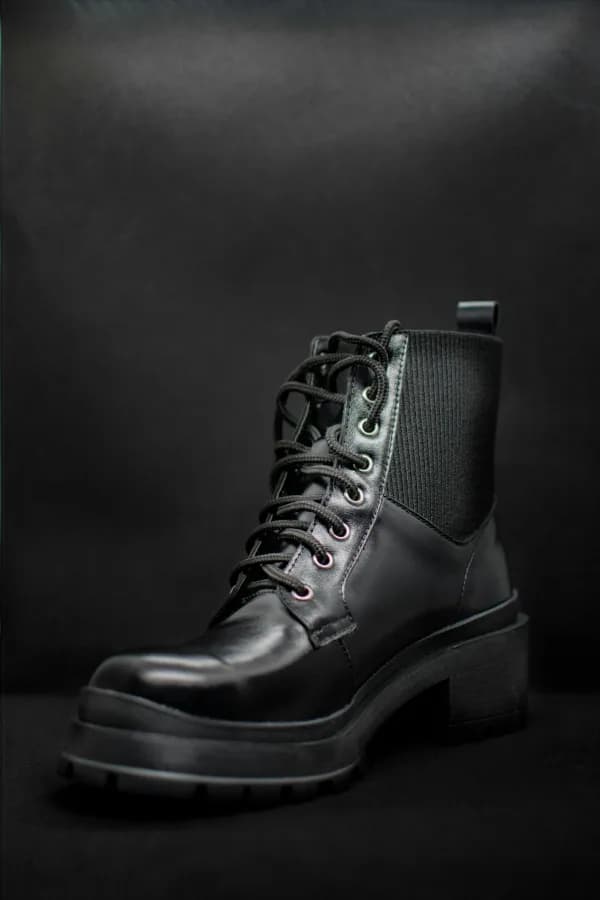 Black leather boots polished by The Shine Drop shoe shine studio Calgary